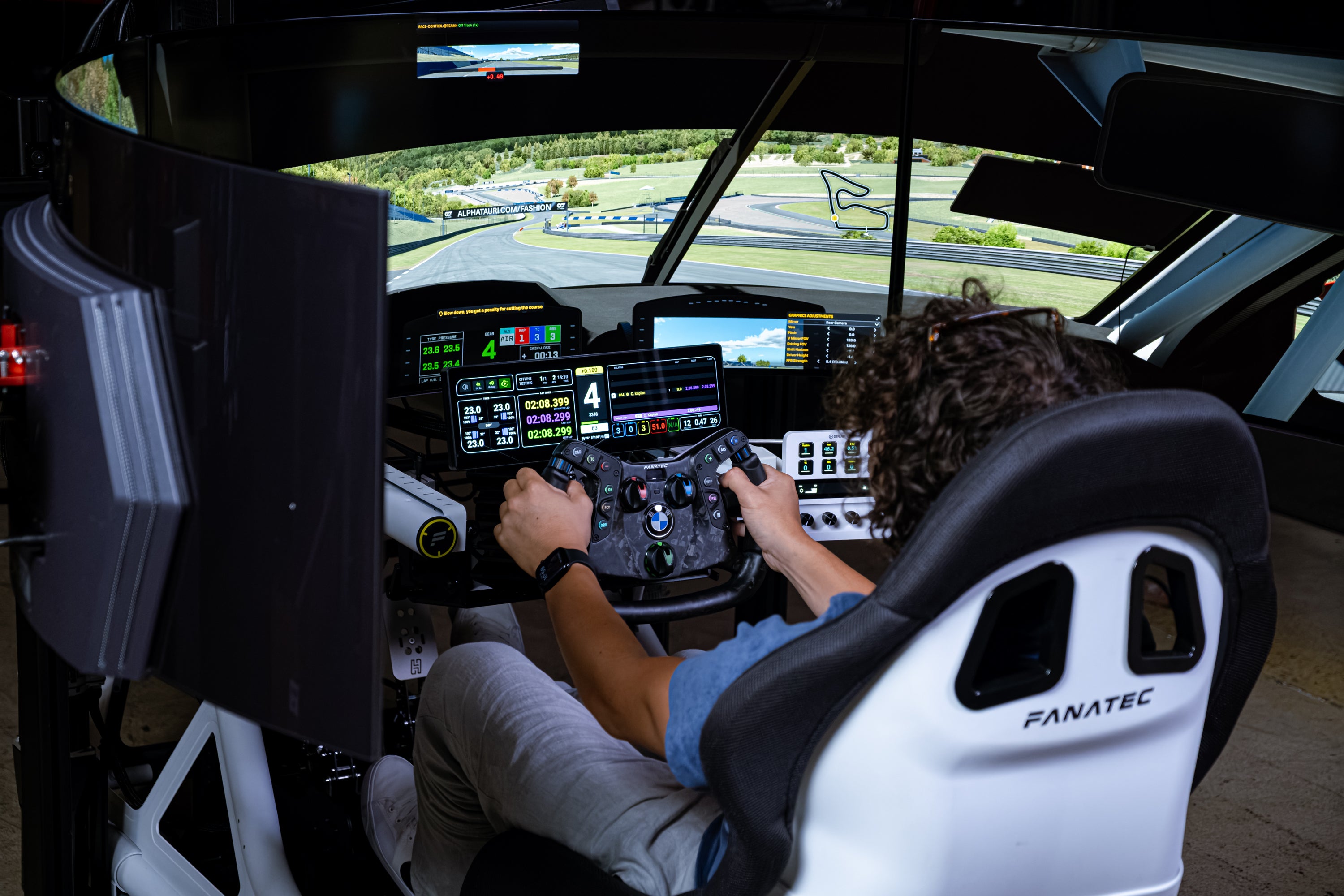 Driver in the Formula Motion simulator, wide shot